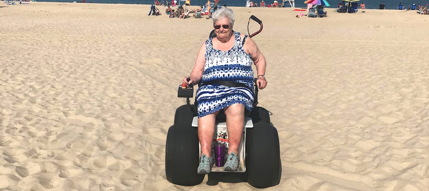 Riding motorized beach wheelchair across sand in Miami, Florida
